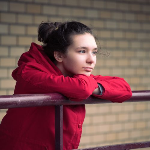 Girl in the red coat from brick walls